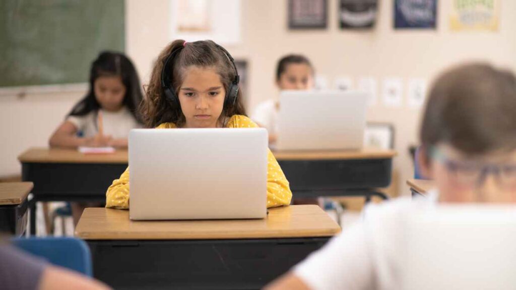 A girl using laptop in classroom