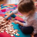 A child counting a large pile of pennies on a colorful play mat.