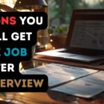 An open laptop, coffee cup, and resume on a desk.